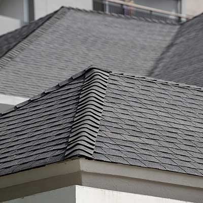 Close up of a large residential roof with gray asphalt shingles