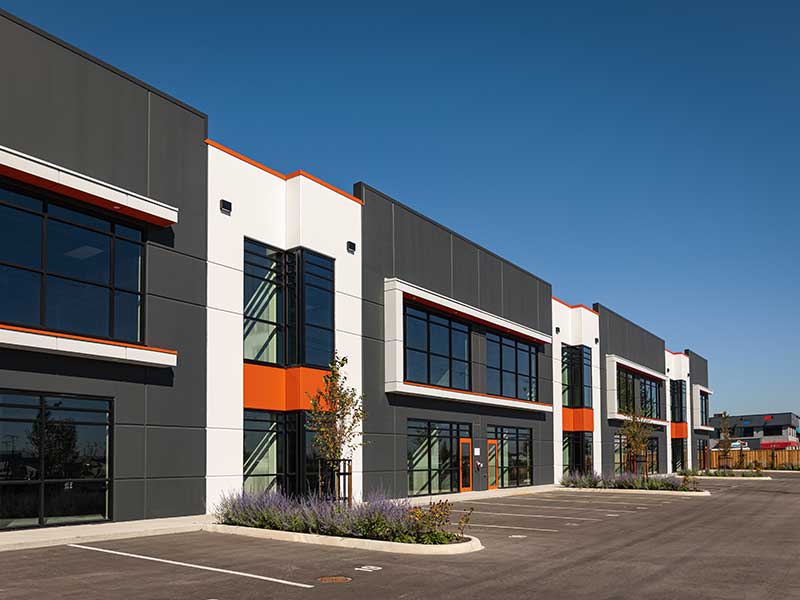 Row of modern, connected white and gray commercial buildings