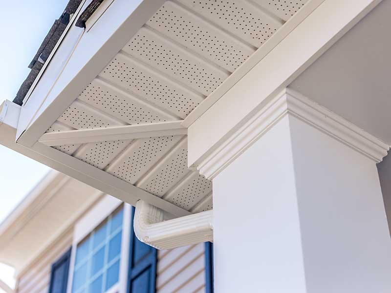 Close up of white soffit and a gutter system attached to the fascia